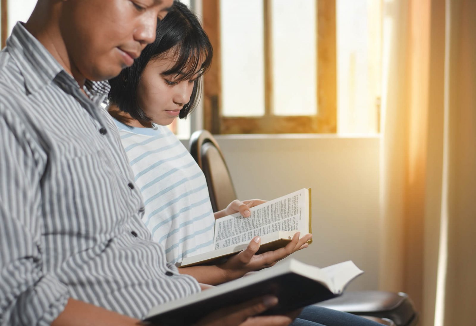 two people reading bibles