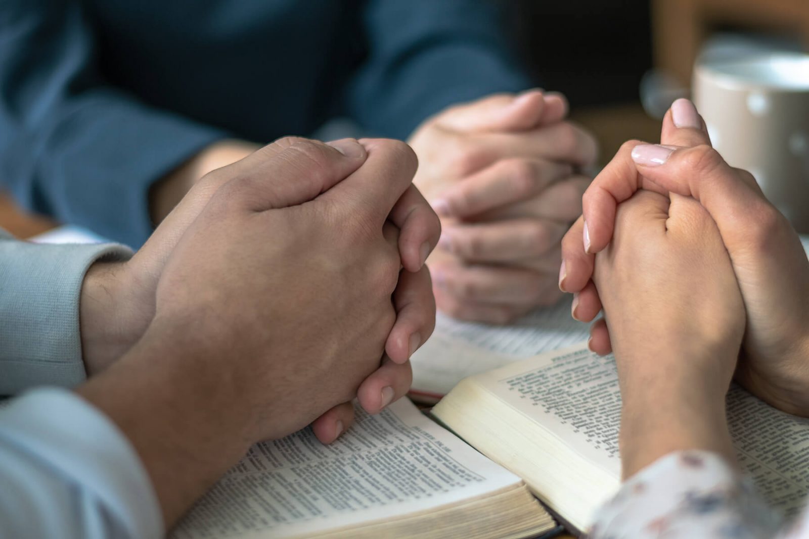 praying over bibles during bible study