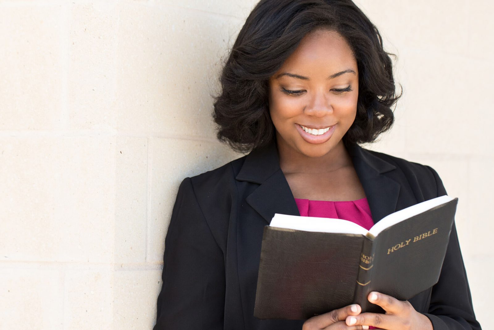 Smiling woman reading the bible