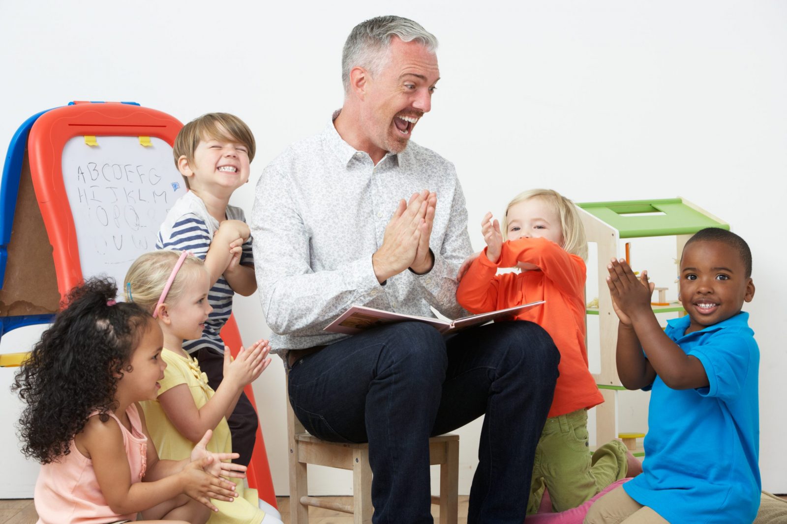 pre-k teacher reading story to children