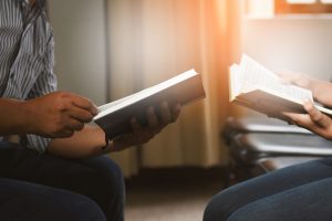 Christian education: Teacher and student reading bible together