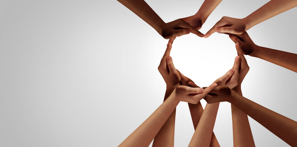 Diverse hands forming a heart